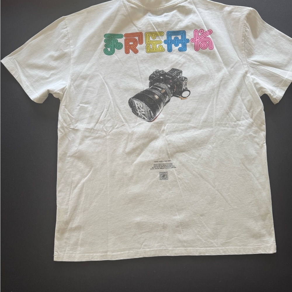 White Graphic Tee with Colorful 'FREE' Lettering and Camera Print